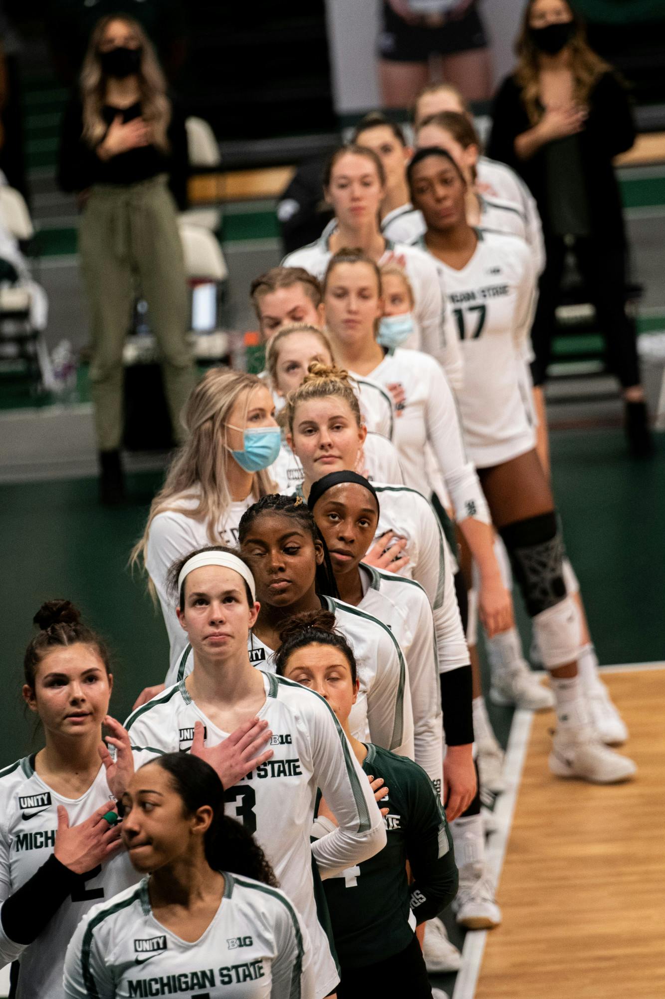 Michigan State Volleyball listens to the national anthem, prior to their loss to Ohio State on Jan. 31, 2021.