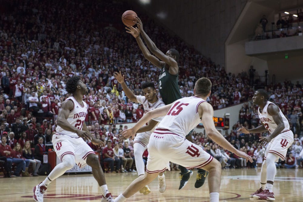 Freshman forward Jaren Jackson (2) goes above the defenders to make a pass during the game against Indiana on Feb. 3, 2018 at Simon Skjodt Assembly Hall. The Spartans lead the Hoosiers 32-24 at half. (C.J. Weiss | The State News) 