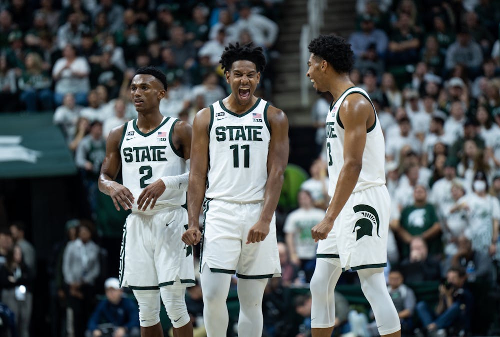 <p>Junior guard A.J. Hoggard (11) and sophomore guard Jaden Akins (3) share a laugh during a game against Villanova at the Breslin Center on Nov. 18, 2022. The Spartans defeated the Wildcats 73-71. </p>