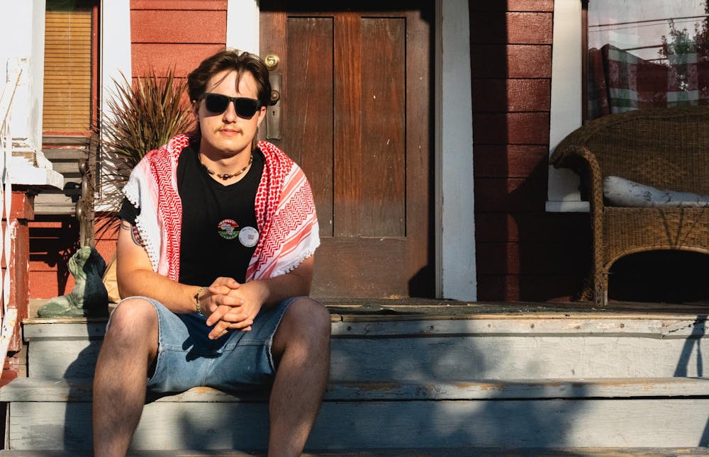 Eli Folts sits on the stairs in Lansing, MI on Sept. 27, 2025