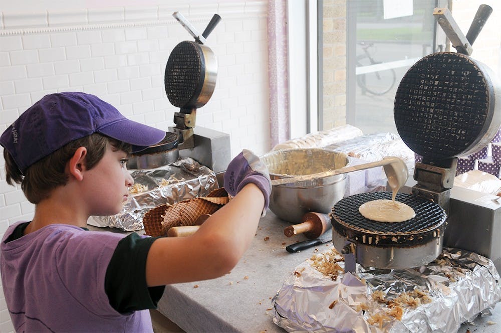 <p>Joey Berakovich, son of the owners Erik and Trisha Berakovich makes a waffle cone July 19, 2015 at Velvet ~ A Candy Store on 507 E. Grand River Ave, the site which once housed InFlight, a smoke shop. Joshua Abraham/The State News</p>