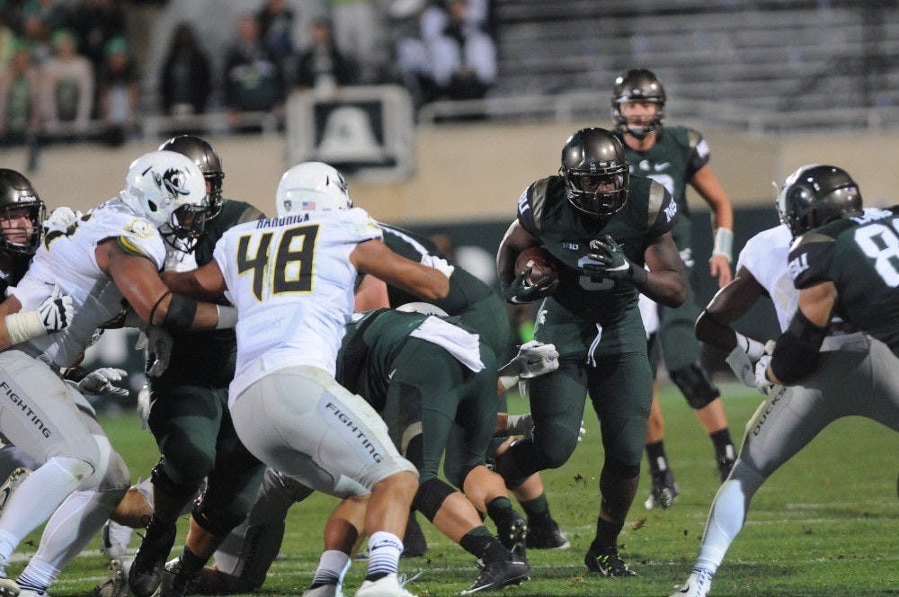 <p>Then-freshman running back LJ Scott runs the ball during the second quarter of the game against Oregon on Sept. 12, 2015 at Spartan Stadium. The Spartans defeated the Ducks 31-28. Joshua Abraham/The State News</p>