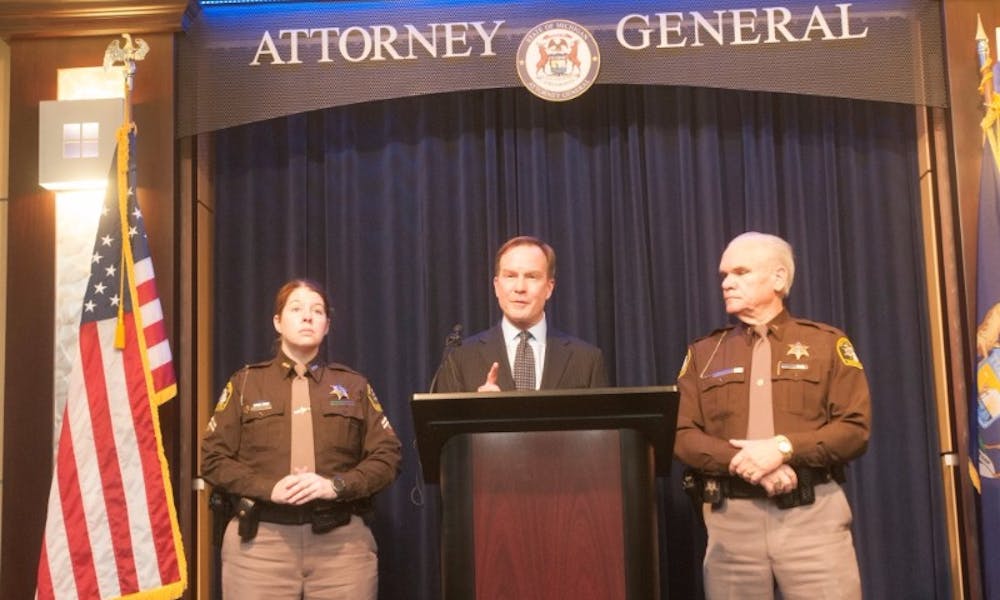<p>&nbsp;Deputy Amber Hinojosa, left, Attorney General Bill Schuette, and former Ingham County Sheriff Gene Wrigglesworth address the press on March 14. 2016 at the William Building on 525 W. Ottawa Street in Lansing.&nbsp;</p>
<p>&nbsp;<strong>STATE NEWS FILE PHOTO</strong></p>