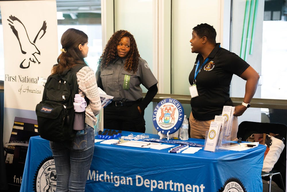 Student talking to employers at the MSU Local Job and Internship Fair held at the Spartan Stadium Office Tower on Sep 7, 2023. 