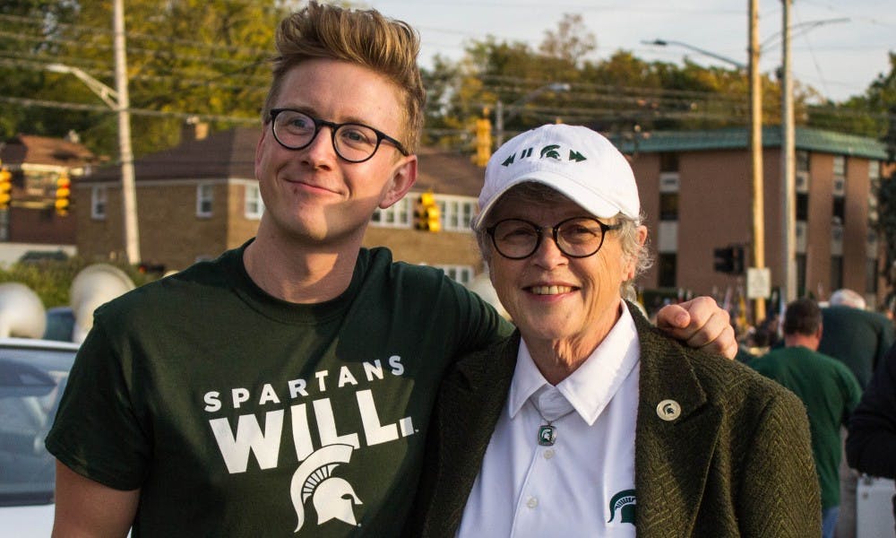 2017 Homecoming Grand Marshall Tyler Oakley poses with MSU President Lou Anna K. Simon before the Homecoming Parade on Oct. 20, 2017 through East Lansing.