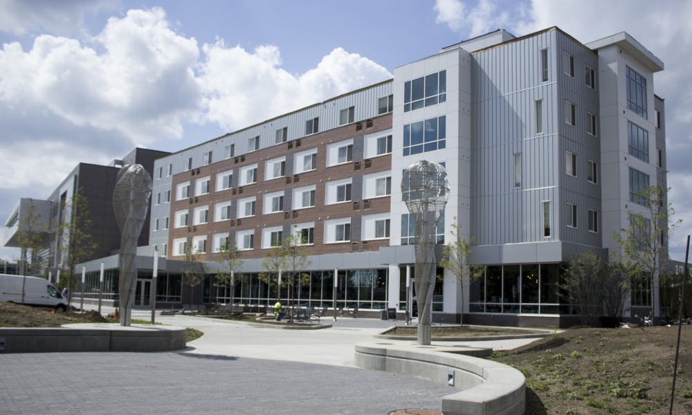 <p>The front of 1855 Place apartments and townhouses is pictured on Aug. 30, 2017. The building is across the street from Breslin Center.</p>