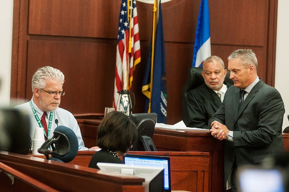 	<p>Deputy Chief Assistant Prosecutor John DeWayne interviews Sparrow Hospital trauma surgeon Ben Mosher during the trial of alleged killer Connor McCowan, Oct. 7, 2013, at Ingham County Circuit Court. Mosher, who treated Singler when he was brought into the hospital, testified that he had no vital signs upon arrival.</p>