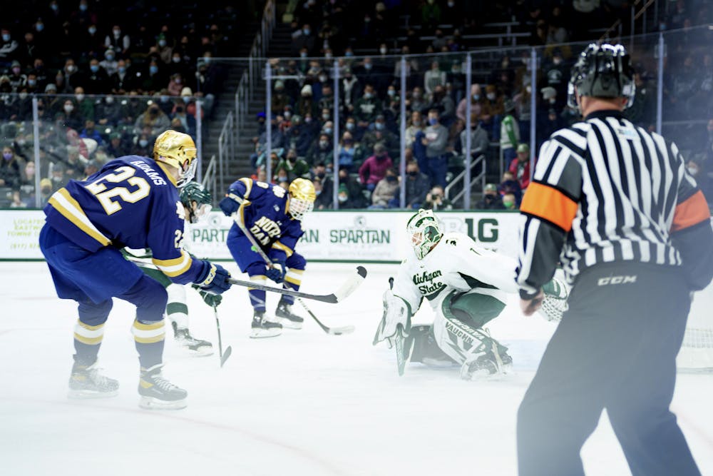 <p>Notre Dame graduate student Jack Adams and freshman Justin Janicke getting a shot off on goal against Michigan State senior Drew DeRidder with Janicke scoring. Taken on Feb. 19, 2022. Spartans lost 4-2 against Notre Dame.</p>