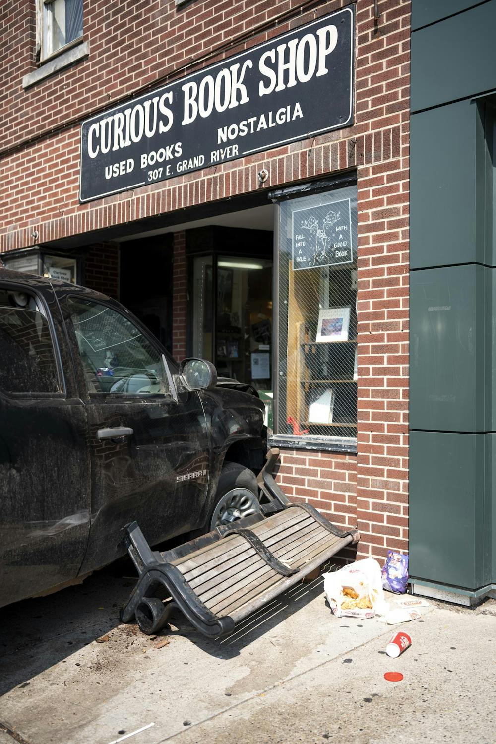 Pickup truck crashes into the front of Curious Book Shop.