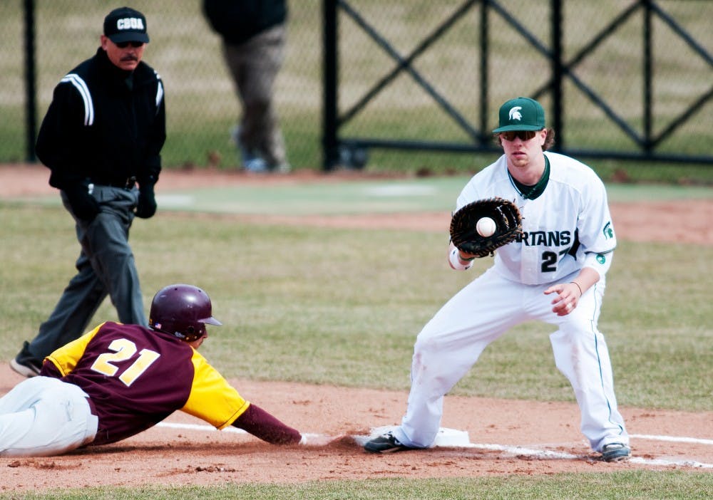 Senior first baseman Jeff Holm tries to catch Central Michigan infiedler Tyler Hall off the base. The Spartans lost to CMU, 3-1, on Wednesday at McLane Stadium at Kobb Field. Josh Radtke/The State News