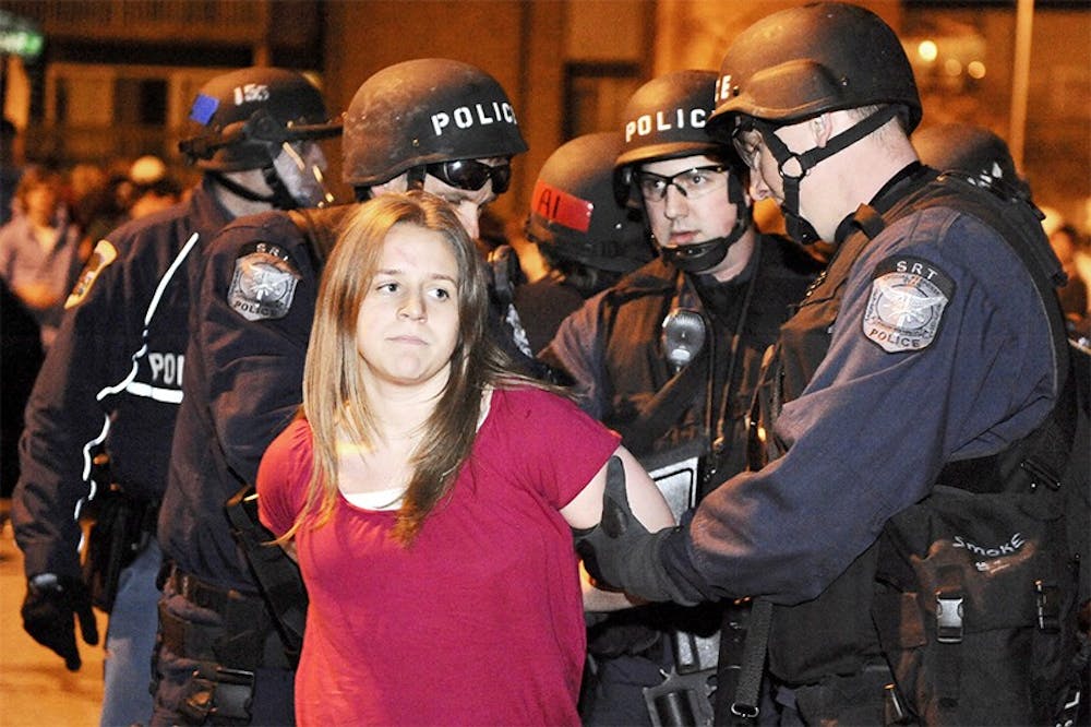 <p>A rioter gets detained by a group of Special Response Team officers at Cedar Fest on April 5, 2008, in East Lansing. Twenty-eight MSU students were arrested. State News File Photo</p>