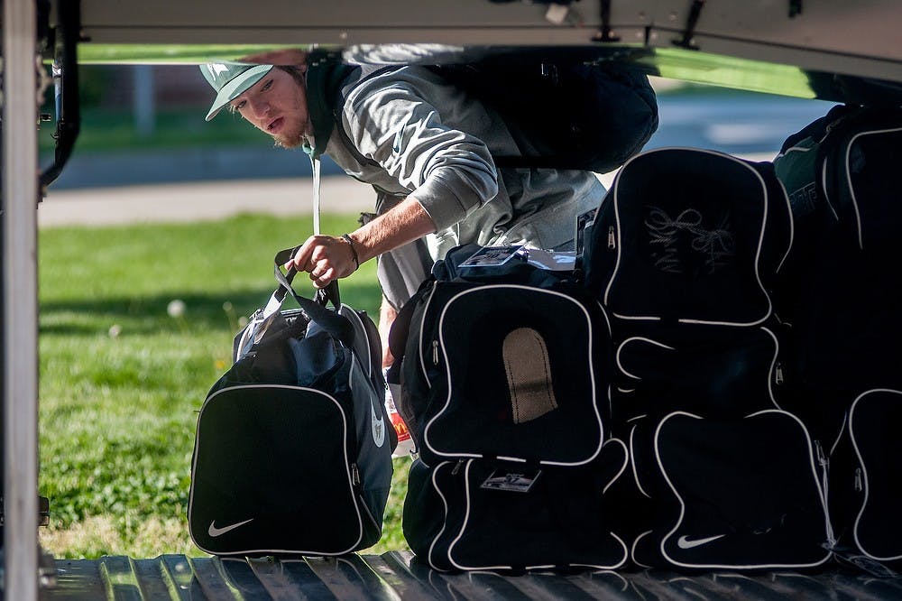 	<p>Sophomore shortstop Ryan Richardson puts his bag onto the bus parked outside Jenison Field House on May, 15, 2013, before the team travels to play Penn State. Justin Wan/The State News</p>