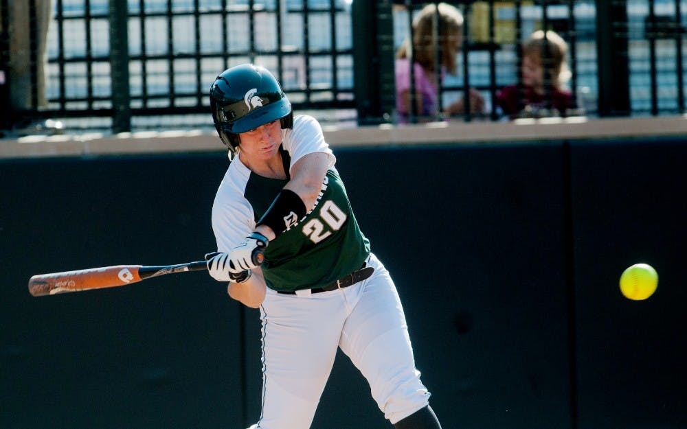 Red shirt freshman utility player Stephanie Sanders swings at a pitch Friday evening at Secchia Stadium at Old College Field.  Sanders recorded a hit and an RBI during a 4-2 loss to Indiana.  Adam Toolin/The State News