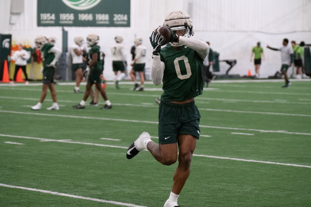 MSU junior wide receiver Keon Coleman catches a pass in a drill at the Duffy Daugherty Football Building on Tuesday, March 14, 2023. The Spartans held their first spring practice on Tuesday as they gear up for the 2023-2024 season.