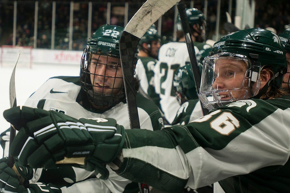 	<p>Senior forwards Lee Reimer, 22, and Greg Wolfe, 86, talk during a break in play in the game against Penn State on Jan. 17, 2014, at Munn Ice Arena. The Spartans defeated the Nittany Lions, 3-0. Danyelle Morrow/The State News</p>