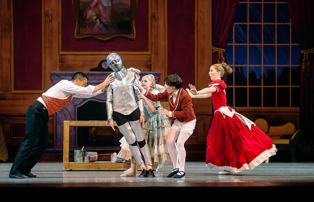 Performers try to hold up up the Armor Doll, played by Audrey Spitzfaden, on Wednesday, Nov. 21, 2012, during the rehearsal of "The Nutcracker." Dancers include children from 8-18 years old. State News File Photo