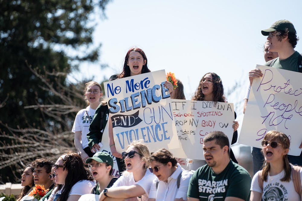 <p>MSU students chant the victims' names who fell to gun violence at a walkout protest against gun violence from Berkey Hall to the Spartan Statue on April 12, 2023.</p>