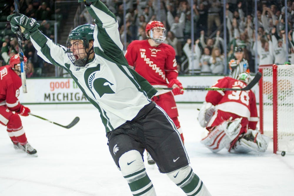 Senior Forward Justin Hoomaian celebrates as he scored the winning goal during the hockey game against Wisconsin on Dec. 11, 2015 at Munn Ice Arena. The Spartans defeated the Badgers, 4-3.