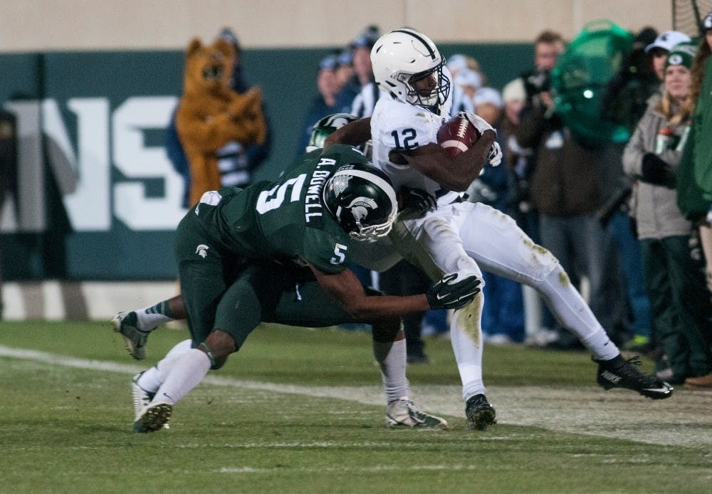 Freshman linebacker Andrew Dowell attempts to take down Penn State wide receiver Chris Godwin during the fourth quarter of the game against Penn State on Nov. 28, 2015 at Spartan Stadium. The Spartans defeated the Nittany Lions, 55-16.