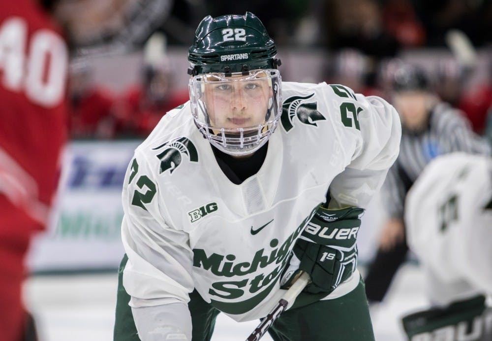 Freshman right defenseman Dennis Cesana (22) waits for the puck to drop during the game against Ohio State University at Munn Ice Arena on Jan. 4, 2018. The Spartans defeated the Buckeyes 8-7 in double overtime.