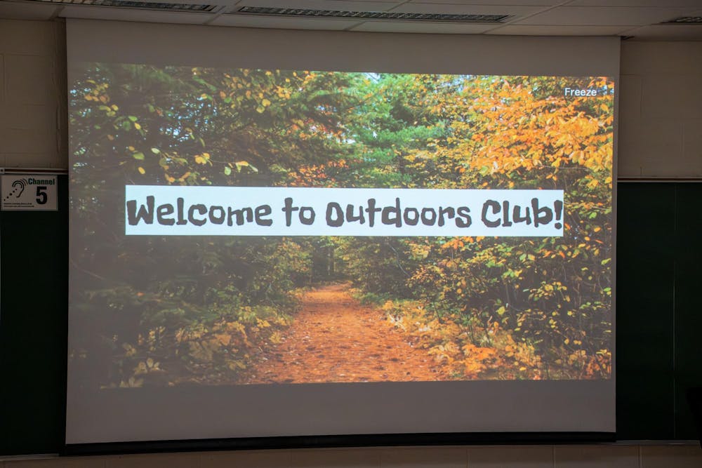 The opening slide of MSU Outdoors Club's meeting projects as members walk in and find their seats on Monday, Feb. 9, 2026, at IM West Recreational Facility in East Lansing, Mich. 