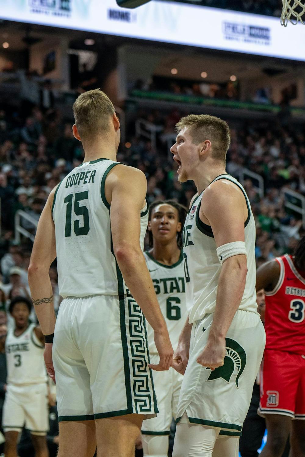 After Michigan State center Carson Cooper (15) dunks the ball, Michigan State forward Jaxon Kohler (0) hypes him up with a yell during Michigan States game against Detroit Mercy at Breslin Center in East Lansing, Mich., on Friday, Nov. 21, 2025.