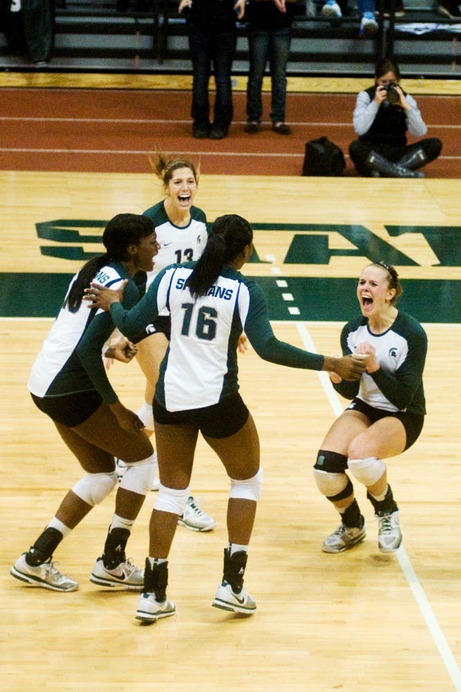 Senior Jenilee Rathje runs over to her team to celebrate a valuable point on Wednesday at Jenison Field House. Each of the four sets played between the Spartans and the Hoosiers were close matches; however, the Spartans brought home a win.