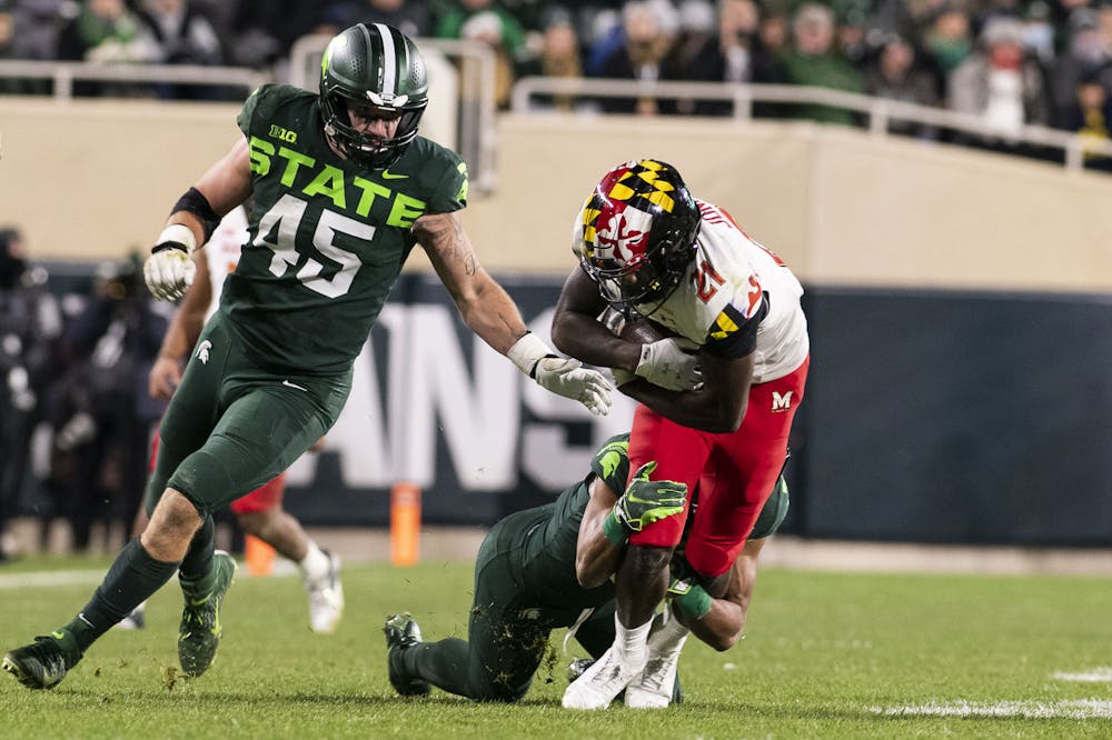 <p>Senior safety Xavier Henderson (3) tackling a Maryland player during the game against Maryland on Nov. 13, 2021, at Spartan Stadium. The Spartans defeated Maryland 40-21.</p>
