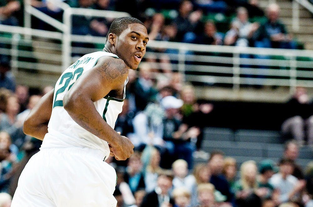 Then-freshman guard Branden Dawson smiles as he runs down the court after dunking the ball. The Spartans defeated the Tigers, 76-41, on Nov. 18, 2011 at Breslin Center. State News File Photo