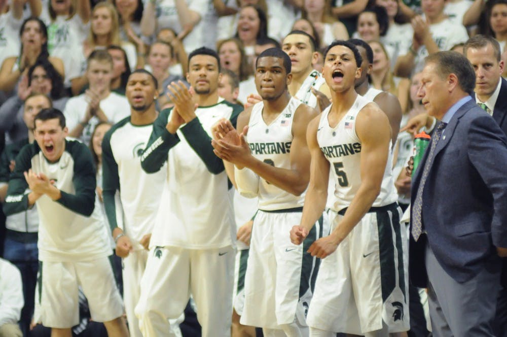 <p>Senior guard Bryn Forbes, 5, and the rest of the MSU Spartans get excited during the game against Northern Michigan on Nov. 4, 2015 at Breslin Center. The Spartans defeated the Wildcats, 94-53.</p>
