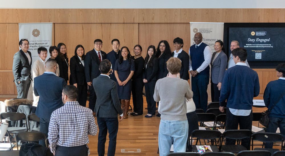 Tina Wei Smith, Co-Vice Chair, and Dennis Chang, Commissioner with the National Asian Pacific American Museum Commission, pose for a group photo with attendees at the Multicultural Center on April 11, 2026.