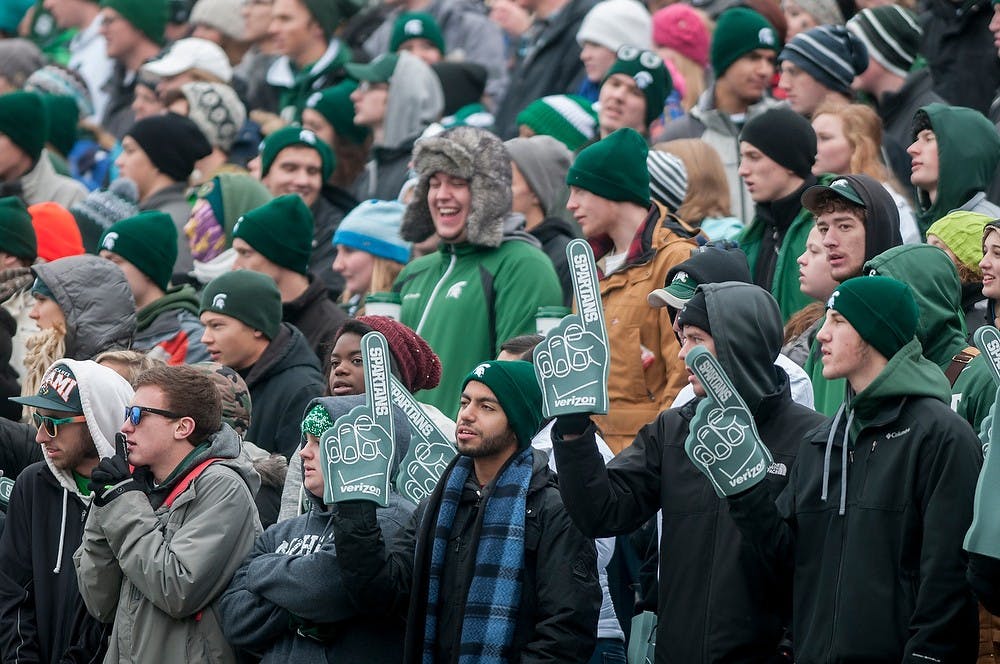 <p>Student section Spartan fans cheer on the team Nov. 22, 2014, during the game against Rutgers at Spartan Stadium. The Spartans defeated Scarlet Knights, 45-3. Raymond Williams/The State News</p>