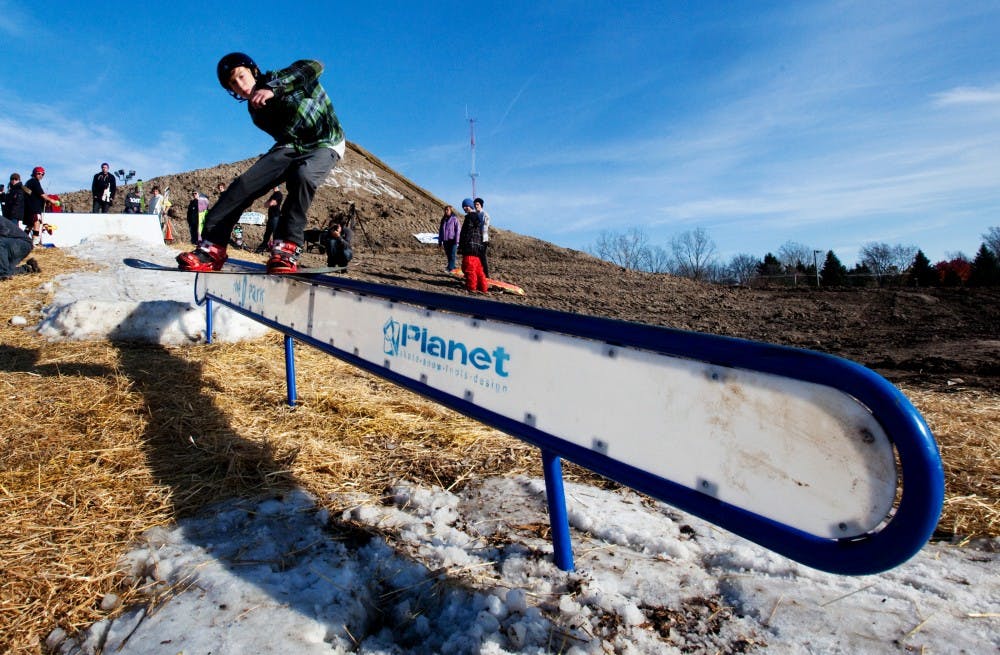 Linden resident Nik Brost, 15, slides down a portable rail set up Saturday afternoon at Hawk Island County Park during the Hawk Island Snow Park Inaugural Open House and Rail Jam. The event was hosted by the Hawk Island Action Sports Operations Committee, or HIASOC, to raise money and awareness for the groups efforts to build a terrain park for skiing and snowboarding. Matt Hallowell/The State News