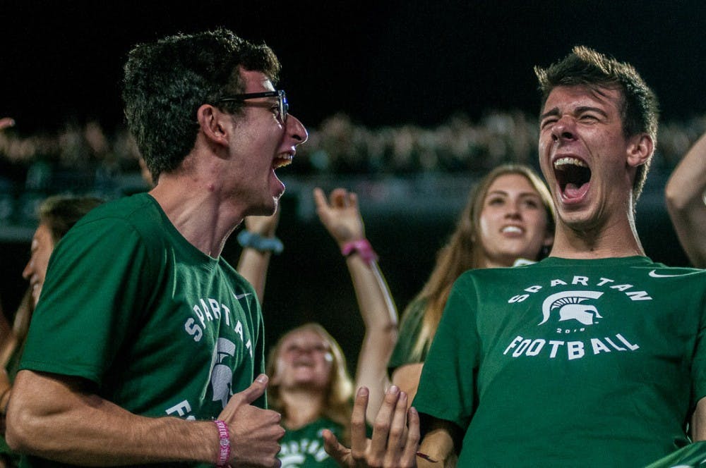 Microbiology and human biology junior Ali Kadouh and supply chain management junior Eric Dekoski react during the game against Utah State on Aug. 31, 2018 at Spartan Stadium. The Spartans beat the Aggies, 38-31.