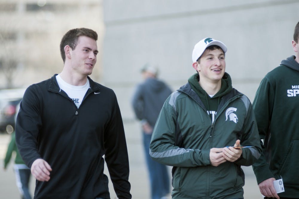 <p>Civil engineering freshman Steven Meister walks with finance freshman Jake Ishbia, Mar. 13, 2015, outside United Center in Chicago. Spartan fans made their way into the building before MSU's first game in the 2015 Big Ten Tournament.  Kelsey Feldpausch/ The State News </p>