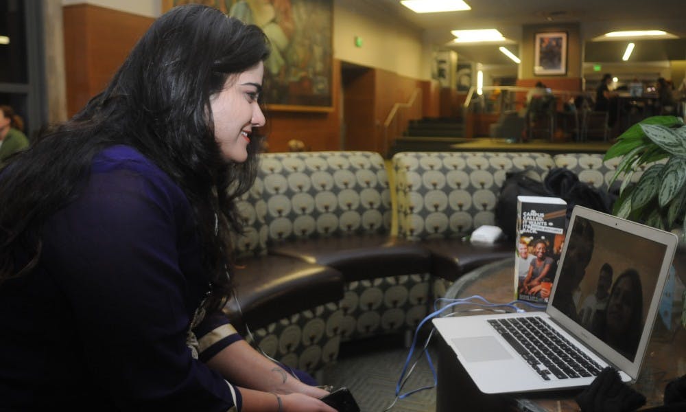 Psychology junior Aishwarya Lonikar skypes with her family on Nov. 11, 2015 inside the Union. Lonikar said she loves campus life at MSU, however she misses her family as well. "It's kind of like a blessing and a curse," Lonikar said. "I had to leave my friends and my family."