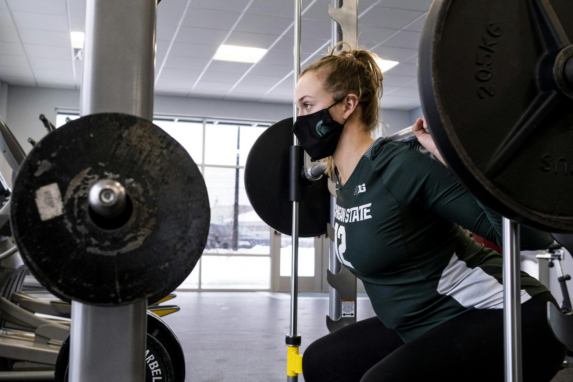 Junior MSU Volleyball player Elena Shkylar doing a weighted squat on February 18, 2021. Elena says the part of her body she likes most about herself are her legs.