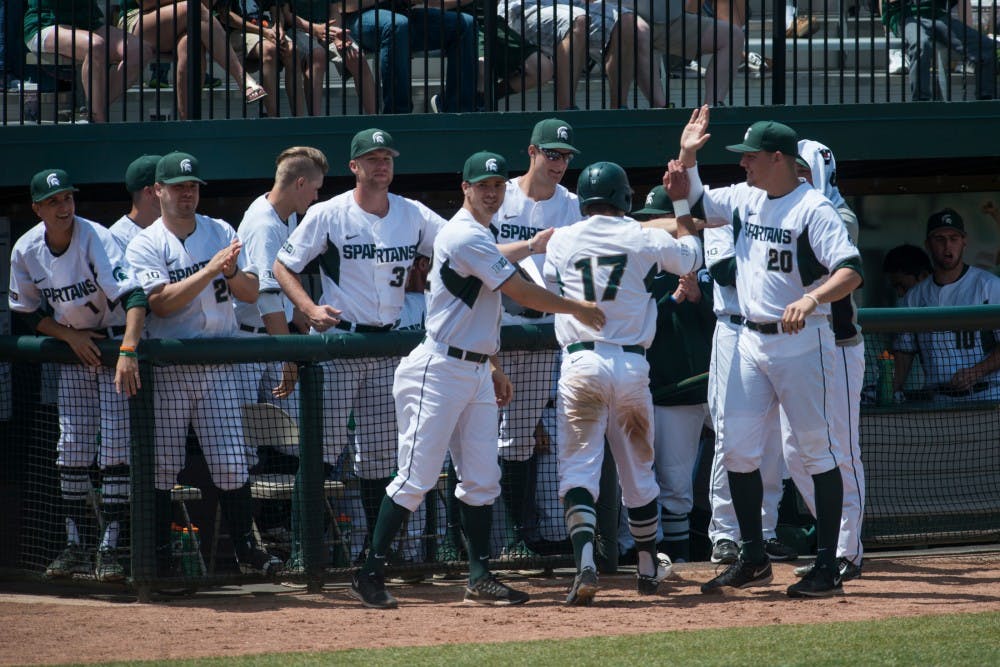 Teammates congratulate senior infielder and outfielder Kris Simonton (17) after scoring a run during the game against Maryland on May 21, 2016 at McLane Baseball Stadium at Kobs Field. The Spartans were defeated by the Terrapins, 6-4.