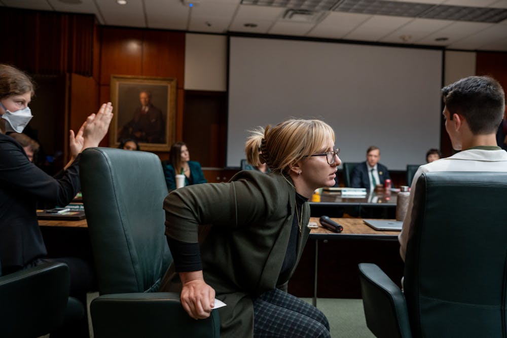 <p>ASMSU President Jo Kovach gets up during the Board of Trustees meeting on Oct. 28, 2022 to give trustee Pat O'Keefe a business card with their number on it.</p>