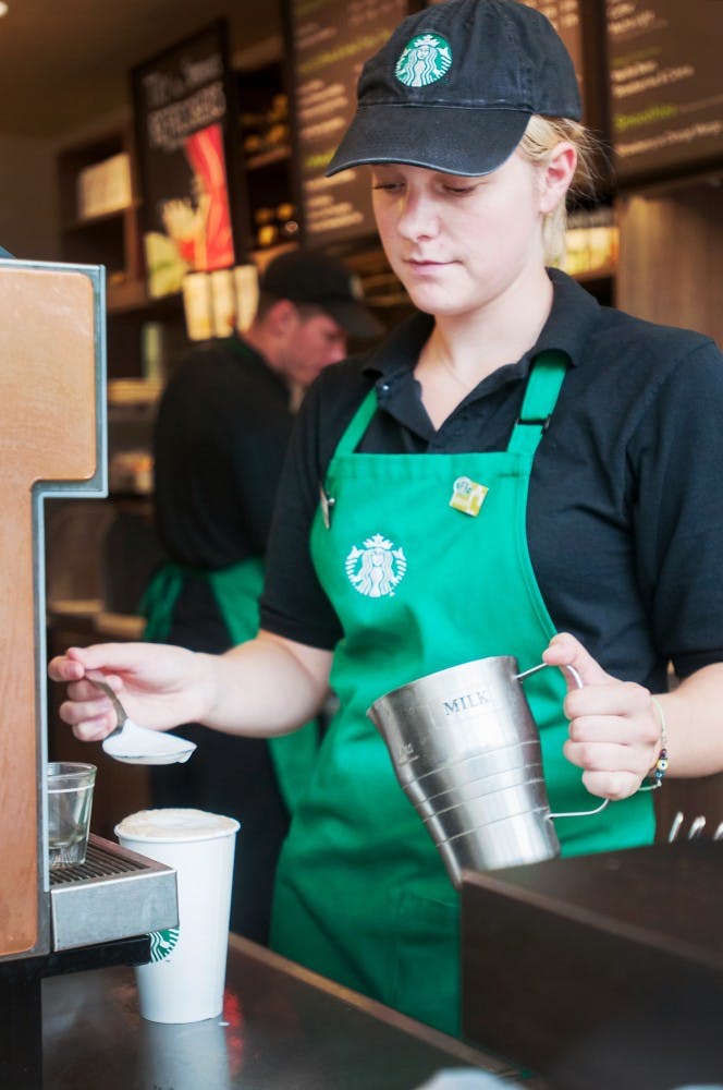 Shift supervisor Emily Snoek prepares a coffee for a customer at the Wells Hall Starbucks location on Friday, July 27, 2012. Starbucks will be opening another location this fall in the Business Complex. Julia Nagy/The State News