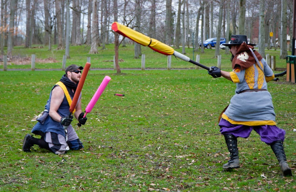 Current Champion of Ashen Hills Michael O'Meara (Master Dong) appears to try and protect himself from Jeff Droulliard (Sicarius) attacks at Ashen Hills LARP in Patriache Park, on May 1, 2022.