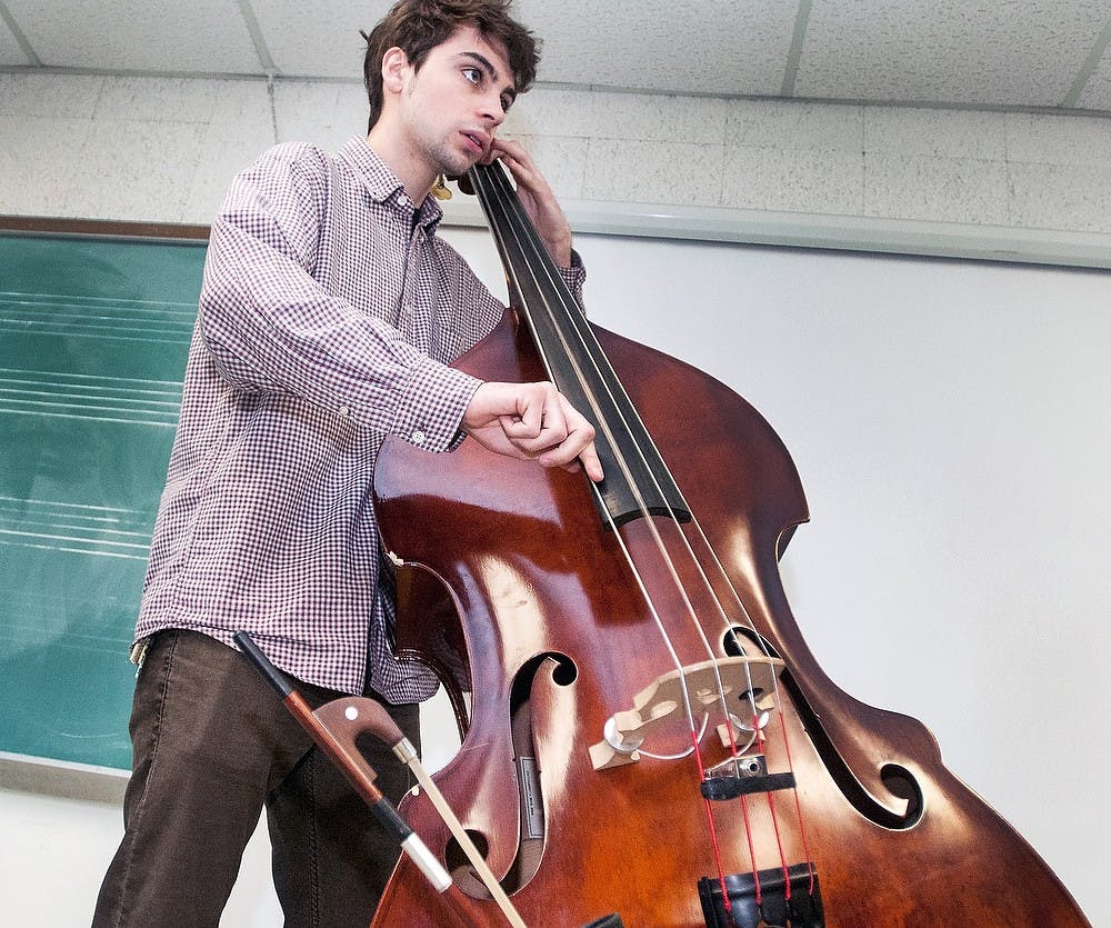 	<p>Jazz studies freshman Duncan Tarr plays the double bass in his improvisational jazz class on Tuesday, Jan. 22, 2013, at the Music Building.  Jazz studies recently received a $1 million endowment from <span class="caps">MSUFCU</span>.  It was the largest investment ever in the music college&#8217;s curriculum. Katie Stiefel/The State News</p>