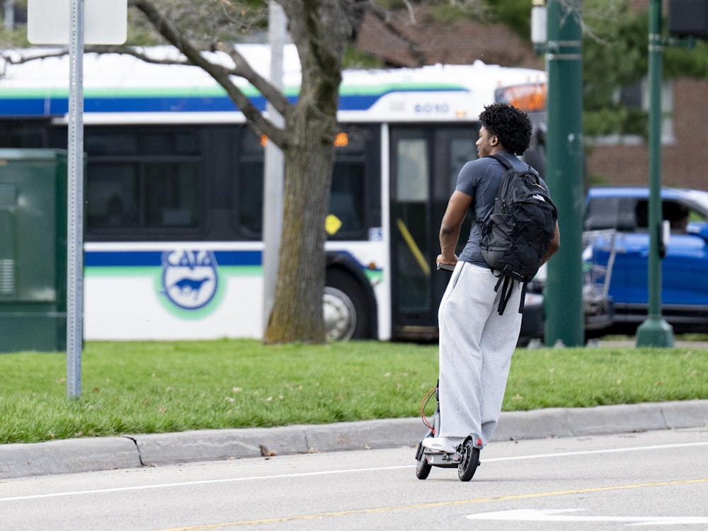 Spartan riding a scooter in the East Neighborhood at Michigan State University campus on April 14, 2025