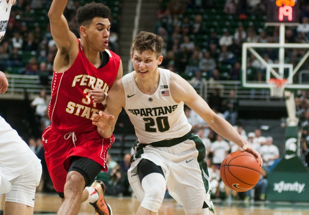 <p>Freshman guard Matt McQuaid rushes to the basket while Ferris State point guard Drew Cushingberry defends on Nov. 9, 2015 during the second half of the game against Ferris State at Breslin Center. The Spartans defeated the Bulldogs, 93-57.</p>