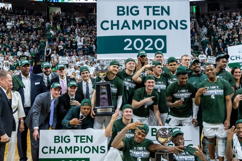The Spartan basketball team poses for photos after winning a share of the 2020 Big Ten Championship. The Spartans defeated the Buckeyes, 80-69, at the Breslin Student Events Center on March 8, 2020. 