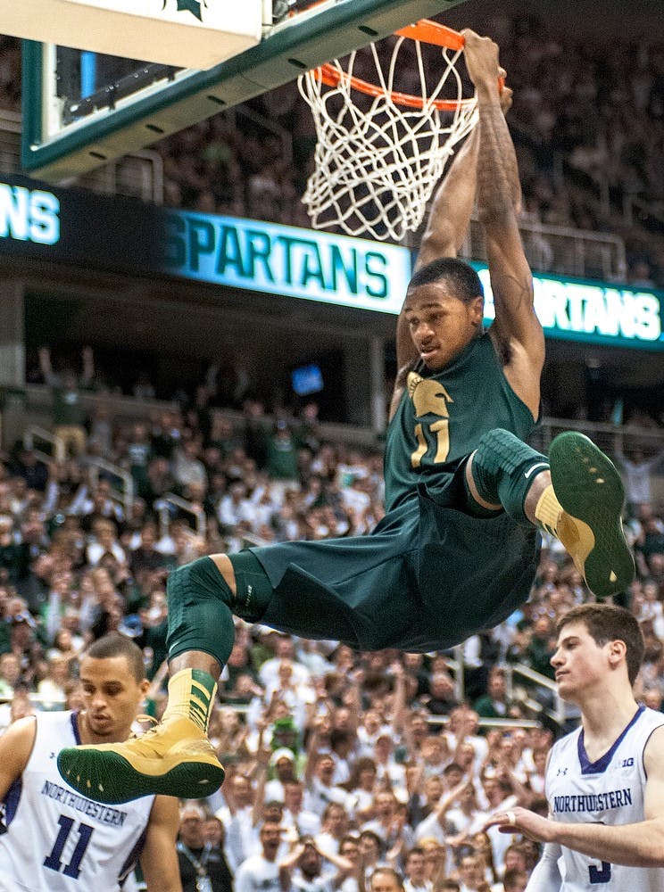 Junior guard Keith Appling about to come down after dunking the basket in the second half of the game. He contributed 16 points for MSU. The Spartans defeated the Wildcats, 61-71, Sunday, March. 10, 2013, at Breslin Center. Justin Wan/The State News