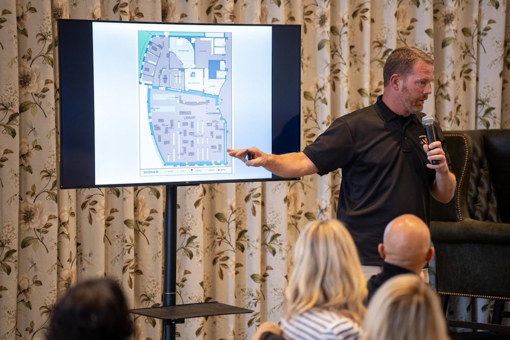 Oakland County Deputy Sheriff Adam Kammer speaks to attendees of MSMSA Fall Focus Symposium on lessons learned from previous shootings using a map of Columbine High School, at the Graduate Hotel, on Oct. 10, 2023.