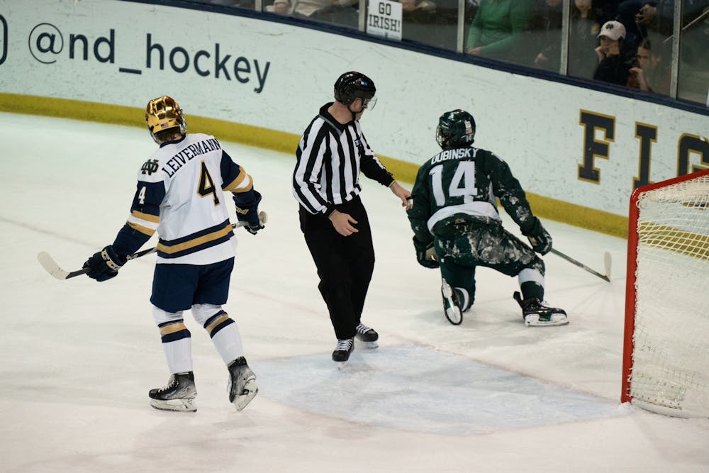 <p>Notre Dame defenseman Nick Leivermann (left) skates away from MSU forward Zach Dubinsky after Dubinsky collided with the net at Compton Family Ice Arena in Notre Dame, IN on Friday, March 4, 2023. The Saturday evening matchup featured 5 more goals than the night before as the Spartans defeated the Fighting Irish 4-2.</p>