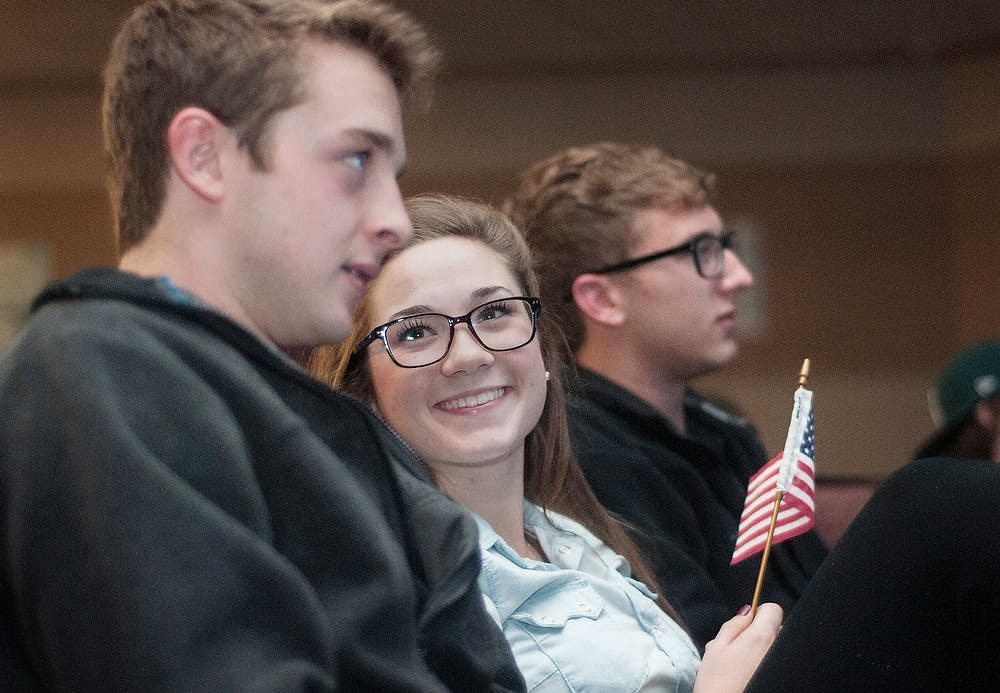 	<p>From left, James Madison freshmen Joe Brennan, Madeline Sigler and Reed Hondzinski talk with one another during the debate in the Wilson Hall auditorium. The event was hosted by <span class="caps">ASMSU</span>. Adam Toolin/The State News</p>