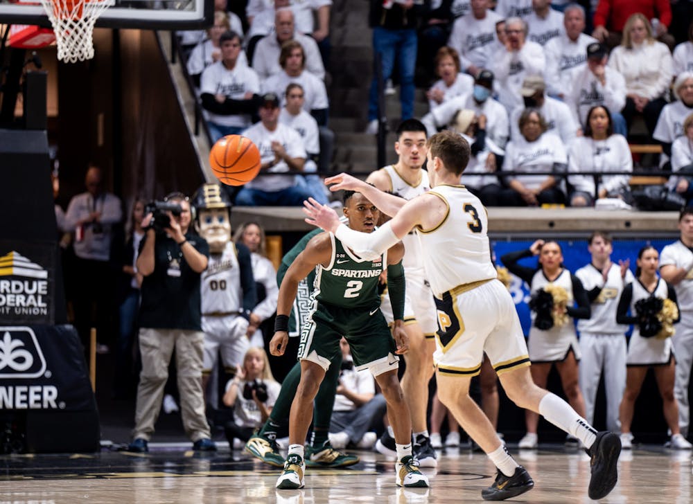 <p>Senior guard Tyson Walker (2) guards Purdue's freshman guard Braden Smith (3) as he passes the ball to his teammate during a game against Purdue at Mackey Arena on Jan. 29, 2023. The Spartans lost to the Boilermakers 77-61.</p>